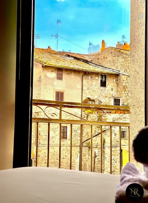Room view over terracotta roofs and peperino stone houses of Viterbo's historic centre
