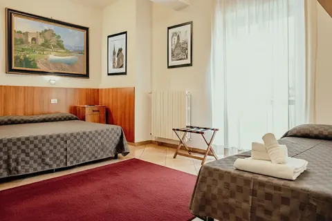 Triple room with wooden panelling and a painting of the Viterbo thermal baths