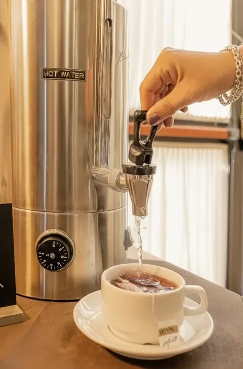 Hot tea from the breakfast room dispenser at Nazareth Residence in Viterbo